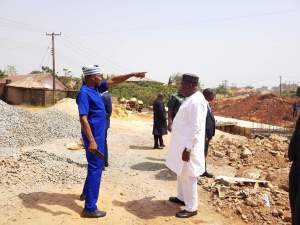 Governor Ifeanyi Ugwuanyi of Enugu State inspects the ongoing flood routing-erosion control